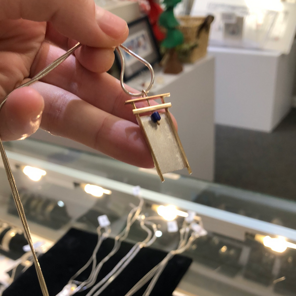 ABSTRACT PENDANT WITH GOLD AND BLUE BEAD