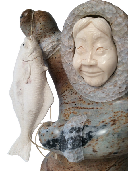 INUIT STANDING HOLDING HALIBUT